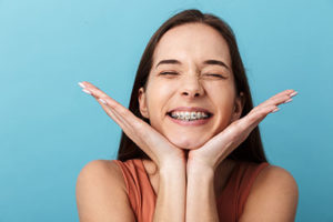 dental braces tx, girl smiling with braces on teeth