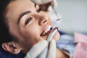 teeth cleaning woodlands tx, woman being worked on by dentist