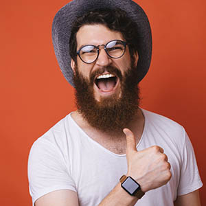 man smiling big and giving thumbs up for teeth whitening service