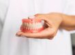 woman holding snap on dentures