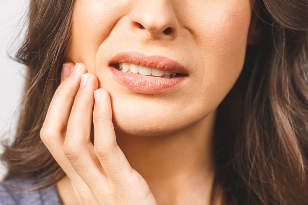 a woman suffering from sensitive gums