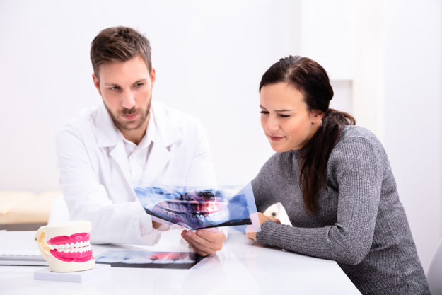 5 Signs You Need Dental Braces Again (6) dentist explaining dental braces